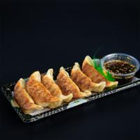 Gyoza* (Chicken) · 6 pcs of chicken pan fried dumpling with gyoza sauce, sesame seeds
