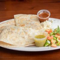Quesadillas · Tortilla that is filled with cheese, choice of meat and then grilled.