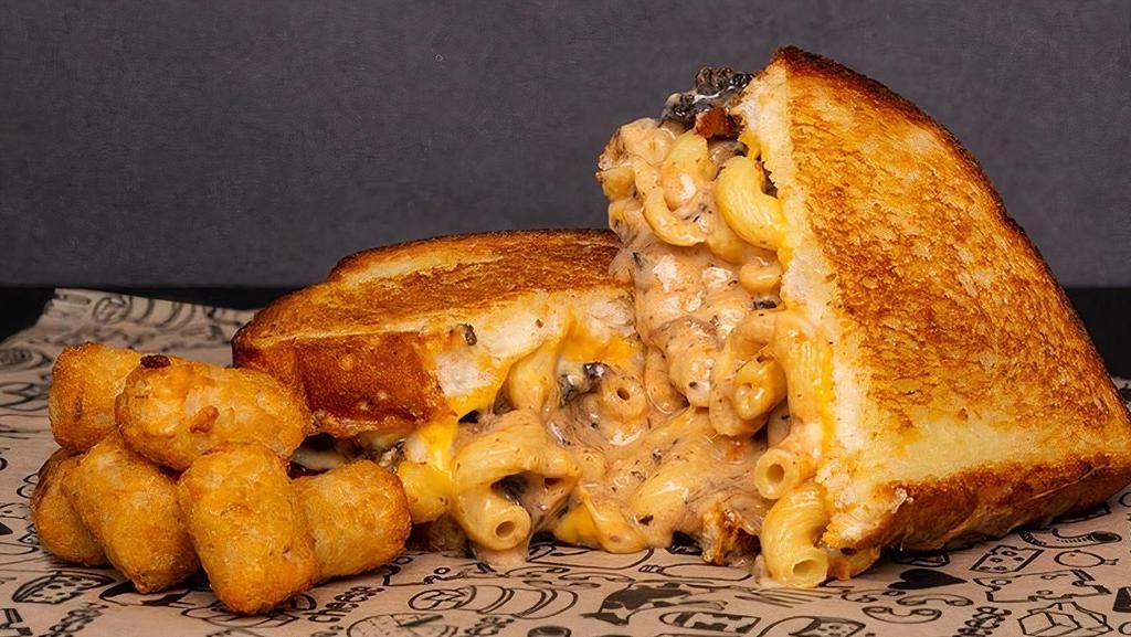 Best Of Both Worlds Grilled Cheese Sandwich  · A Baked Mac & Cheese Sandwich with Slow-Cooked Short Rib, White Cheddar Cheese, and American Cheese finished off with BBQ Sauce.
