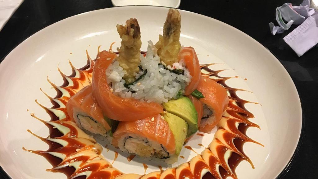Tango Roll · Two Shrimp Tempuras, Crabmeat, wrapped around with Seaweed & Rice & Sesame Seed, topped with Salmon & Avocado, with Four Season sauce. (Raw)