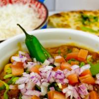 Dal Thadka · Vegan. Yellow lentil curry sautéed in garlic, curry leaves, dry red chilies with mustard see...