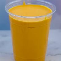Mango Lassi · Churning curd (yoghurt) is blended with curd, mango pulp and seasoned with sugar.