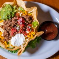 Taco Salad · On taco shell with monterrey jack and cheddar, fresh guacamole, sour cream and salsa with ch...
