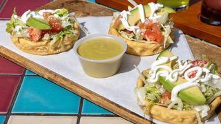 Sopes · Vegetarian. Three corn cakes filled with black beans, shredded lettuce, and tomatoes, then t...