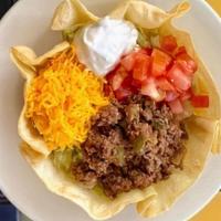 Taco Salad · A home-style taco shell with ground beef, fresh lettuce, tomatoes, sour cream, and Cheddar c...