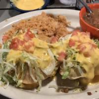 Puffy Tacos · Two puffy corn shells filled with ground beef or shredded chicken, lettuce, tomatoes, and ch...