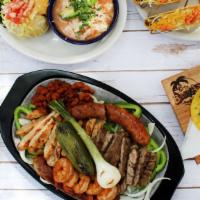 Mixed Grill · Served with both chicken and beef fajitas, a jalapeño-cheddar sausage link, al pastor pork, ...