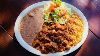 Carne Guisada · Tender beef tips cooked in a Mexican-style gravy. Served with Mexican rice, refried or charr...