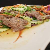 Beef Salad · Grilled beef with Green onion, Tomato, Cucumber, Cilantro, Lettuce mixed with lime juice.