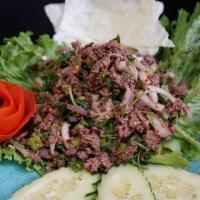 Larb · grounded Chicken, tossed in chili powder, red onion, rice powder, cilantro, and lime juice. ...