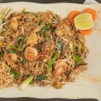 Pad Thai · Stir-fried rice noodles with egg, bean sprouts, green onions, tofu and topped with crushed p...