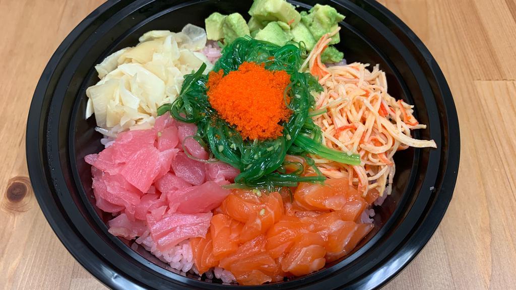 Poke Bowl · Tuna, salmon, spicy crab, avocado, ginger, seaweed salad, and masago bedded on rice.
