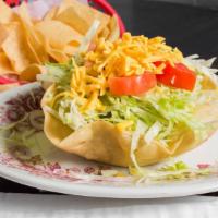 Taco Salad · Fried flour tortilla bowl, ground beef or chicken, lettuce, tomatoes, cheese.