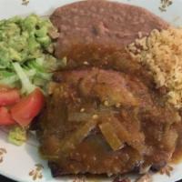 Carnitas Rancheras · Fried pork pieces, salsa, guacamole salad, rice, refried beans, tortillas.