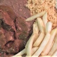 Plate Lunch De Carne Guisada · Beef tips in homemade gravy, salad or French fries, rice, refried beans, tortillas.
