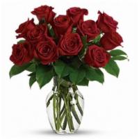 Red Rose Bouquet · A classic red rose arrangement designed in a clear glass vase, haloed in seasonal greenery. ...