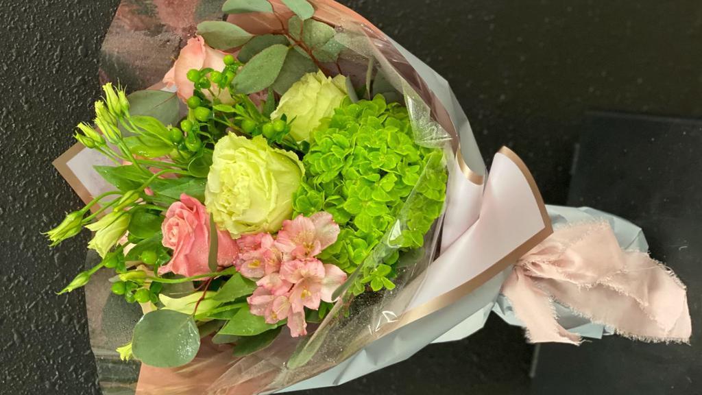 Blushing Blossoms Wrap · This presentation wrap features a collection of soft blush, creme & green hues of elegant seasonal florals & foliage.  Featuring a minimum of 12 premium floral stems, this bouquet is delivered gift wrapped  in a water source.