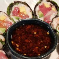 Carribean Roll · Salmon, tuna, yellowtail, Crab meat, mango, avocado, spring mix wrapped with rice paper with...