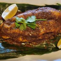 Ikan Bakar · Malaysian style grilled fish fillet over banana leaves topped with chef special sambal sauce.