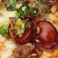 The Little Piggy · House rubbed a brisket, mac and cheese, white queso, smoked sausage, BBQ sauce, sour cream, ...