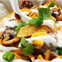 Frito Pie · Loaded with beef chili, queso, cheddar, chili cheese Fritos, jalapenos, sour cream, and chiv...