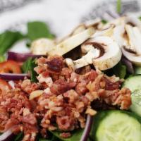 Spinach Salad · Fresh spinach, red onion, bacon bits, tomatoes, mushrooms, and cucumber.