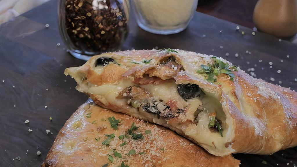Stromboli Calzone · Pepperoni, Italian sausage, fresh mushrooms, black olives, green bell peppers, all-natural, mozzarella cheese, with our homemade pizza sauce.