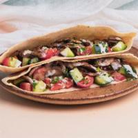 Mushroom Pita Sandwich · Roasted mushrooms with diced tomato and cucumber, chopped parsley, and a tahini drizzle wrap...