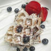 The Blueberry Belgian Waffle · Delicious blueberry waffle topped with powder sugar served and butter with maple syrup