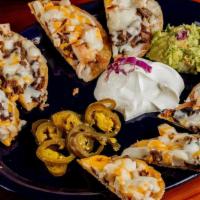 Nachos Supreme · Your choice of meat with refried beans, shredded cheese, guacamole, sour cream and sliced ja...