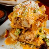 Flauta Stack · Beef or chicken flautas stacked and topped with chile con queso, refried beans, guacamole an...
