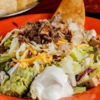 Fajita Taco Salad · Fresh mixed greens topped with chicken fajita, pico de gallo, shredded cheese and guacamole.