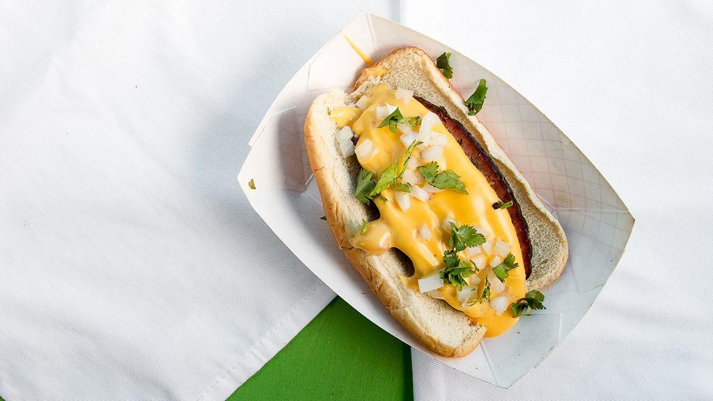 The Texas Dawg · Brisket stuffed hot link, topped with queso, onions and cilantro.