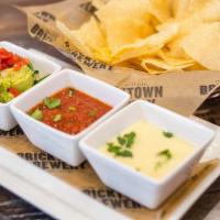 Dipping Trio · White queso, fresh guacamole, housemade salsa, bottomless tortilla chips.
