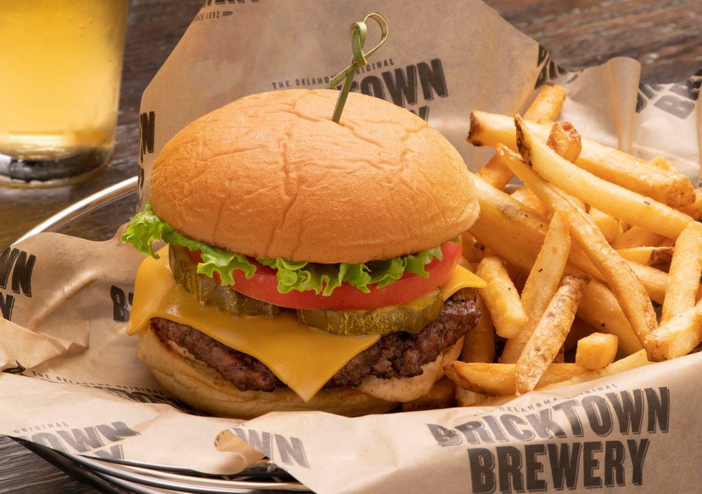 Double Bricktown Burger · Two Creekstone Farms Black Angus Beef patties, two slices of American cheese, tomato, pickles, leaf lettuce, burger sauce on a martin potato bun.