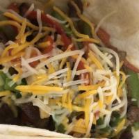 Tail Gate · Sirloin steak fajita with grilled onions and pepper topped with mixed cheese, served on flou...