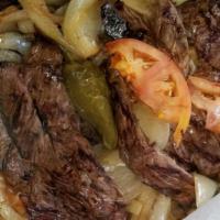 Carne Asada · 10 oz. marinated steak, topped with sautéed onions and peppers, served with tortillas.
