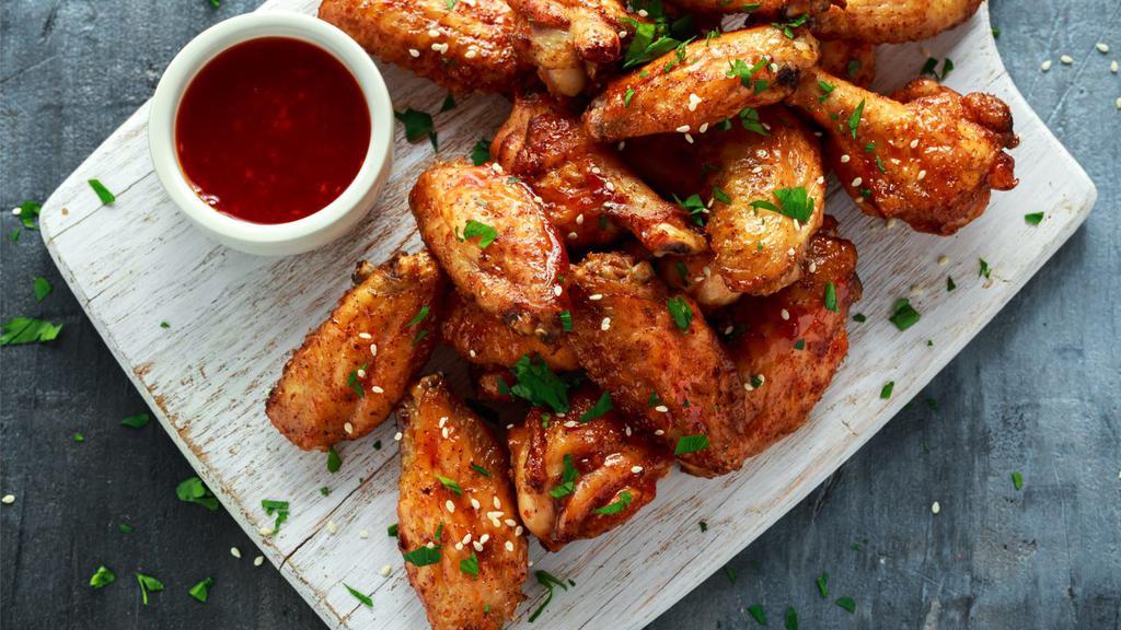 Asian Zing Wings · Crispy, fried wings with a mouth-watering, sticky, sweet and spicy wing sauce.