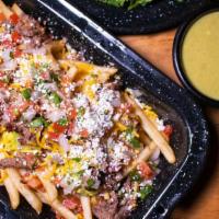 Famous Carne Asada Fries · french fries topped with guacamole, carne asada, cheddar cheese, pico de gallo and queso fre...