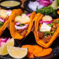 Tacos Al Pastor · corn or flour tortilla, pork seasoned with a fusion of middle eastern and Mexican spices gri...