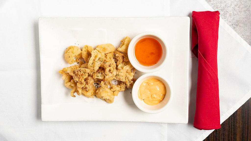Thai-Style Calamari · Succulent calamari, battered fried to golden brown. Served with spicy mayo and lemongrass fish sauce.