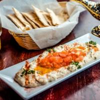 Baba Ghanoush · Baked eggplant blended with Tahini and some lemon and garlic. Served with pita bread
