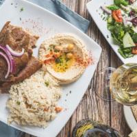 Gyro Plate · A blend of lamb and beef thinly sliced. Served with rice, hummus, tzatziki, feta salad and p...