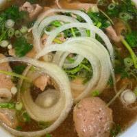 Phở With Meatballs (Phở Bò Viên) · Phở Bò Viên. Traditional beef noodle soup topped with various fresh herbs and served with sp...