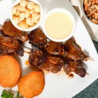 Anticuchos · Grilled beef heart chunks served in a kebab-style. Served with Peruvian white corn and potat...