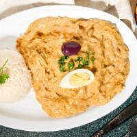 Aji De Gallina Limeno · Shredded chicken breast in a Parmesan cheese, pecan and yellow pepper sauce. Served with pot...