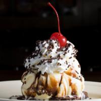 Warm Brownie · Topped with vanilla ice cream, whip cream, and chocolate sauce.
