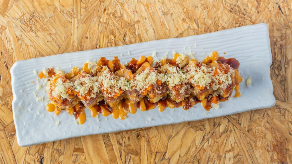 Hot Mama Roll · *Spicy* Tempura fried (smoked salmon, cream cheese, and avocado) and topped with spicy tuna, masago, scallions, crunchy flakes, spicy mayo, and sweet soy