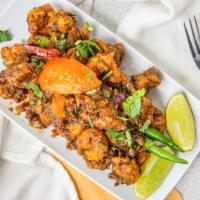 Curry Leaf Chicken · Deep fried chicken sautéed with freshly crushed peppers corns, onions and green chilies and ...