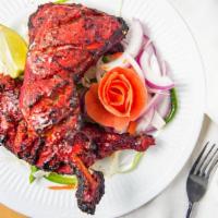 Tandoori Chicken · Spicy. Marinated in spicy sauce and cooked on skewer in tandoori clay oven with mesquite cha...